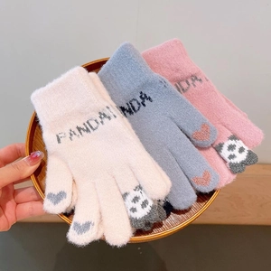 Detail of knit gloves featuring panda patterns and heart shapes on fingertips