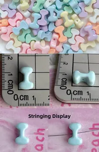 Macro detail of candy-colored bone-shaped resin beads with size scale and stringing demo