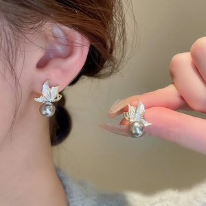 Golden butterfly stud earrings with grey pearl drops and white enamel wing details