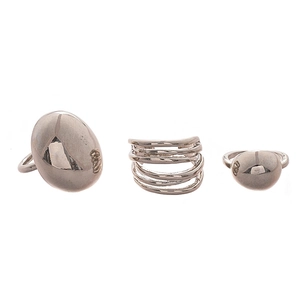 Three-piece set of polished silver geometric rings featuring oval and multi-layer designs
