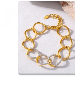 Close-up of interlocking gold rings with diamond-set accents and metallic texture