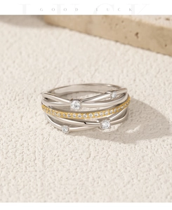 Macro view of S925 sterling silver layered ring with gold accent and inlaid diamonds