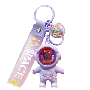Purple astronaut keychain with silicone charm and SPACE printed strap on white background