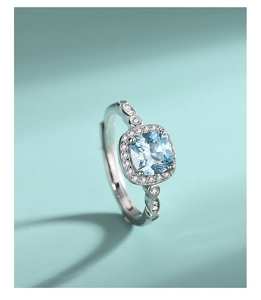 Macro shot of S925 sterling silver ring with halo set blue square cut gemstone