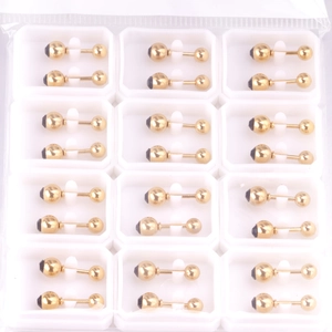 Macro shot of gold dumbbell stud earrings with black screw backs in bulk packaging