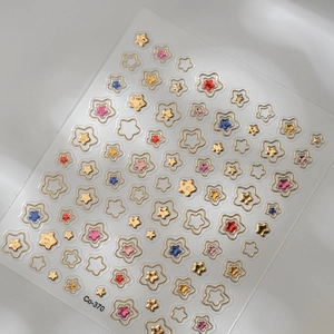 Detailed view of hollow heart and colorful sequin star nail stickers with golden finish