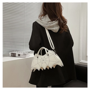 Detail view of white bat shaped PU leather handbag with embroidered spider web pattern