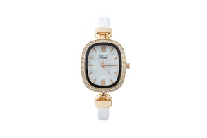 Close-up of golden oval quartz watch with white leather strap and diamond-encrusted bezel