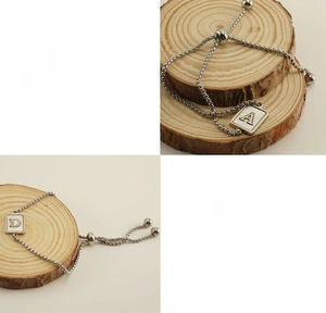 Detailed view of titanium steel adjustable bracelet with square initial shell pendant