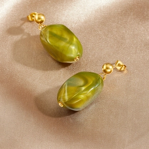 Vintage gold stud earrings featuring olive green resin drop pendants on silk