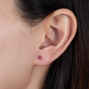 Macro shot of pink zircon three-petal flower stud earrings in gold-plated sterling silver