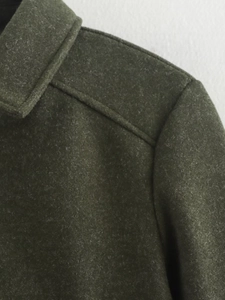 Detail of dark green textured wool jacket collar and shoulder stitching craftsmanship