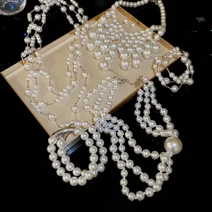 Elegant multi-layer pearl necklace set with matching bracelet and earrings in a silver finish