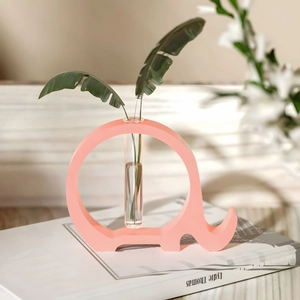 Detail of pink elephant-shaped resin hydroponic vase with a clear glass test tube