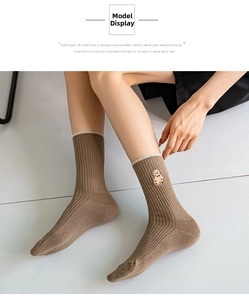 Detail view of cotton mid-calf socks featuring a cute brown teddy bear embroidery