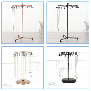 Rotating jewelry display stand with multiple hooks and stable metal base for necklaces