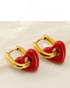 Macro detail of 18K vacuum plated gold U-shaped hoop earring with red heart enamel pendant