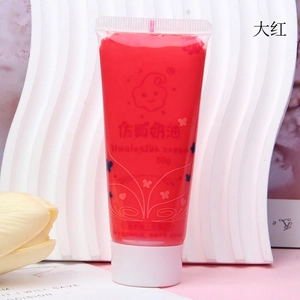 Close-up of 50ml bright red imitation cream glue tube with piping tip for DIY phone cases