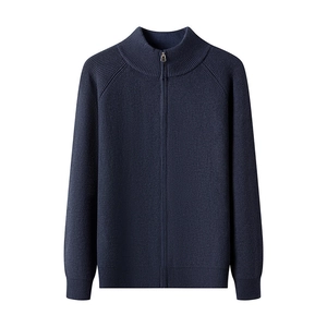 Detail of navy knit cardigan with full-length zipper closure and ribbed stand collar