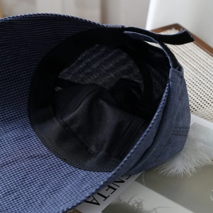 Blue plaid wide-brim sun hat for women featuring adjustable strap and mesh lining