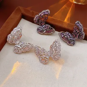 Elegant micro-set cubic zirconia butterfly studs in silver and purple crystal finishes