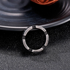 Close-up of vintage industrial razor blade ring in aged silver finish on dark background