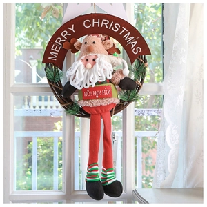 Detail of Christmas wreath with plush Santa and Reindeer on a cozy window background