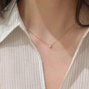 Minimalist single zircon pendant necklace on titanium steel chain shown on model