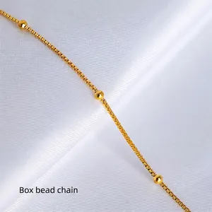 Classic 18K gold-plated box beaded chain necklace elegantly displayed on white silk