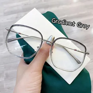 Macro detail of gradient gray square glasses frame with striped metal temple tips