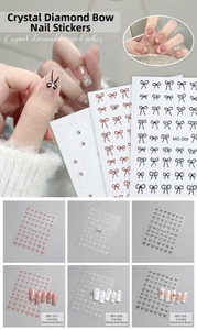 Close-up of 5D bow nail art stickers with crystal rhinestones in red, black and white