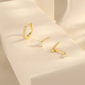 Detailed close-up of S925 sterling silver gold earrings set with cubic zirconia stones