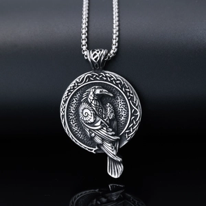 Macro detail of vintage silver Viking raven pendant with intricate Nordic engravings