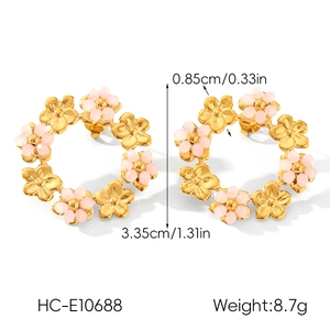 Detail view of gold flower hoop earrings with pink beads showing dimensions and weight