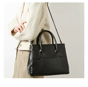 Detail of the black embossed crocodile leather texture on this large capacity handbag