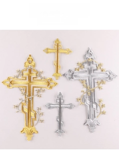 Macro detail of gold and silver cross embroidered patches with metallic stitching