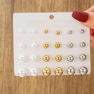 Detail of 12-pair colorful pearl and metallic stud earring set in varied sizes on a card