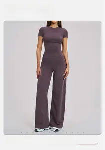 Detail of high-waist wide-leg pants and slim fit yoga set in brushed matte fabric