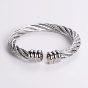 Detailed view of the twisted cable texture and polished ends of the silver steel cuff bracelet