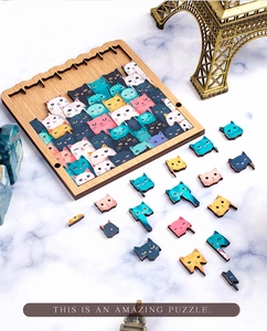 Detail of wooden cat puzzle pieces on a marble surface with an Eiffel Tower model