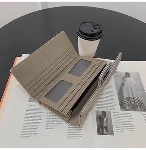 Detail of grey Saffiano leather long wallet with multiple card slots and clear ID window