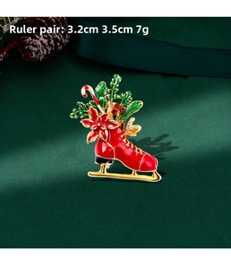 Detail of Christmas ice skate brooch with red and green enamel and 3.2cm x 3.5cm dimensions