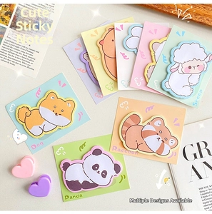 Flat lay of cute animal sticky notes including panda and dog styles with soft pastel colors