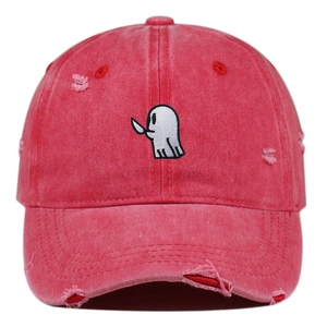 Detailed view of red washed cotton baseball cap with ghost embroidery and distressed holes