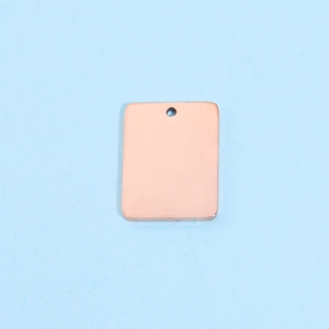 Detailed top view of a polished rose gold rectangular stainless steel pendant on light blue