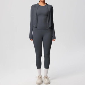 Three-piece dark grey yoga set with zip-up jacket, slim top and high-waisted leggings