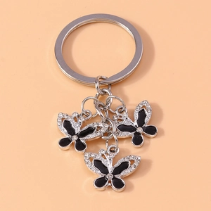 Close-up of triple butterfly keychain with black enamel and sparkling rhinestones