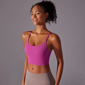 Close-up of vibrant rose pink longline yoga bra with thin straps and deep round neckline