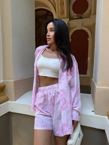 Close-up of pink floral pajama set featuring long-sleeved shirt and drawstring shorts