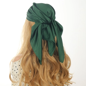 Deep green satin square silk scarf 70x70cm shown as a stylish headwrap on a model